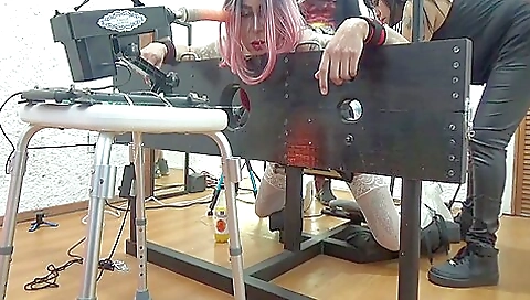 Busty brunette getting fucked on a bed in a bondage scene